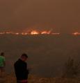 People watch the fire that scorched Penteli, on the outskirts of Athens, Greece, on Tuesday, July 19, 2022.