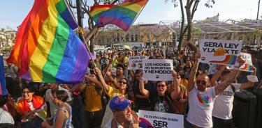 Integrantes de la comunidad LGBT muestran pancartas y carteles a las afueras del Congreso del Estado