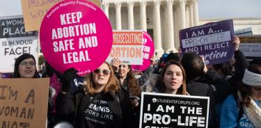 (FILES) In this file photo taken on January 18, 2019, pro-choice activists hold signs alongside anti-abortion activists participating in the 