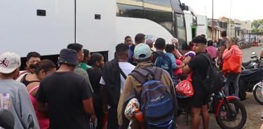 Migrantes hacen fila para abordar uno de los ocho autobuses del 'Corredor emergente de movilidad', este martes en Tapachula